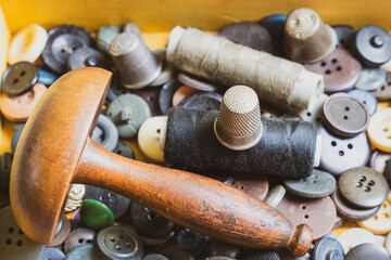 Collection of vintage sewing tools in an old sewing box