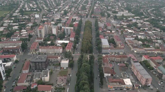 Aerial view Zugdidi city center boulevard with traffic, mixed housing and offices, investment growth potential &mdash; concepts: real estate, mobility, urban growth, infrastructure, economy, development
