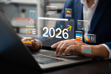 2026 Goals, Businessman analyzing futuristic dashboard data with growth charts and financial projections for year 2026, showing digital trends, strategy planning, Target, investment insights.