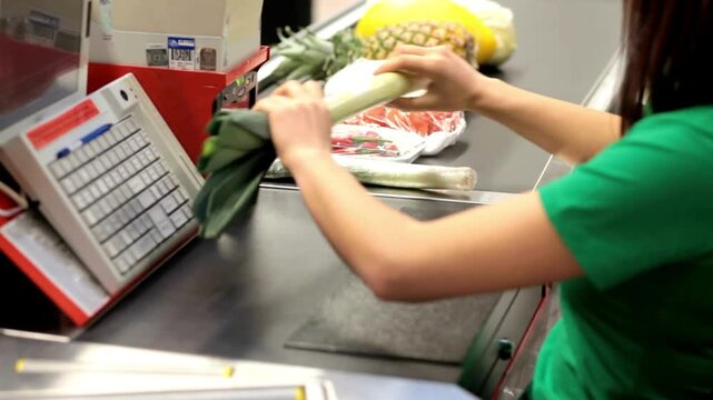Hands of cashier check out goods line of items Workers and customer at supermarket checkout consumer