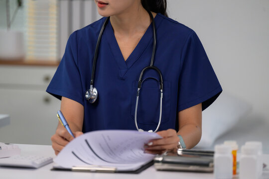 Medical professional writing patient notes in clinic