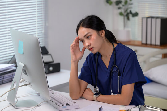 Asian female nurse experiencing stress and professional burnout