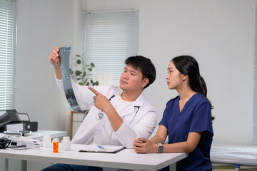 Doctor and nurse reviewing x-ray film together