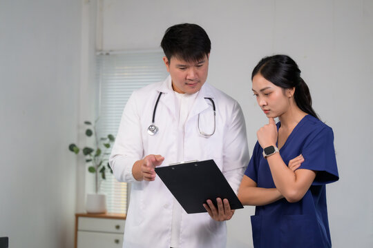 Medical team collaborating discussing patient clipboard healthcare