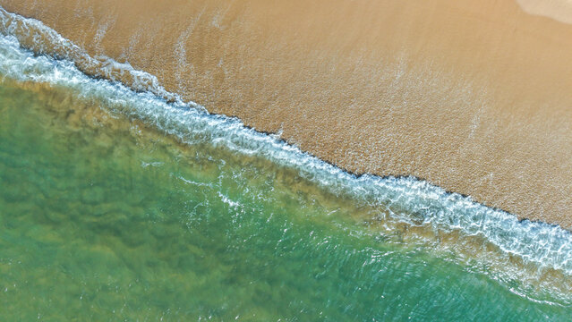 Summer seascape beautiful waves, blue sea water in sunny day. Royalty high-quality free best stock of tranquil beach with turquoise waves splashing, sand shore. Aerial view, tropical nature background