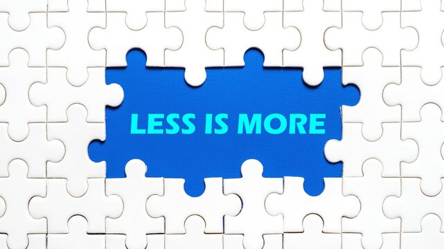 The concept of writing LESS IS MORE in the middle of the puzzle with a blue background. - Powered by Adobe