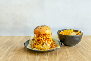 Gourmet burger with Galician blonde beef, melted smoked   cheese, RAF tomato, and romaine lettuce between toasted brioche buns with clarified butter