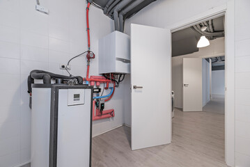 Efficiently laid-out laundry room: washing machine, boiler, and ironing area with built-in...