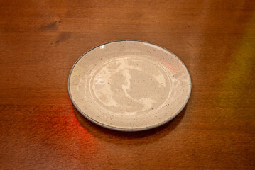 Glazed ceramic plate in a deep , a saturated color that dominates the composition with its vibrant presence