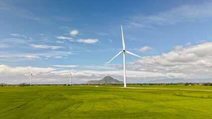 Green rice fields with wind turbines in rural Vietnam. Royalty high-quality free best stock of...