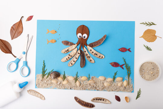 diy creative flat lay tutorial collage with octopus and fish from leaves pods seeds on blue background underwater project activity for kids useful for eco campaigns children learning publishing, - Powered by Adobe
