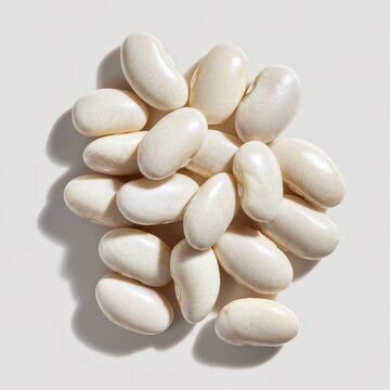 Isolated on bright white background, pile of raw white kidney beans arranged neatly with clean studio shadows. Ultra-sharp detail, premium food ingredient photography, ideal for nutrition