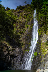Obraz premium A beautiful mountain waterfall. The water falls into a lake. The waterfall is in Bolivia.