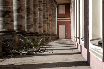 A balcony of an abandoned palace with columns. Beautiful columns. Sunny day.