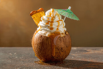 Banana cream pina colada served in carved coconut with tropical garnish