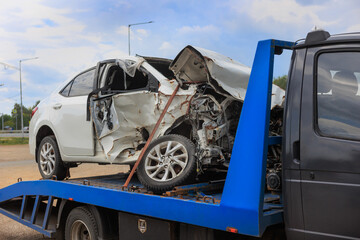 wrecked car on a tow truck