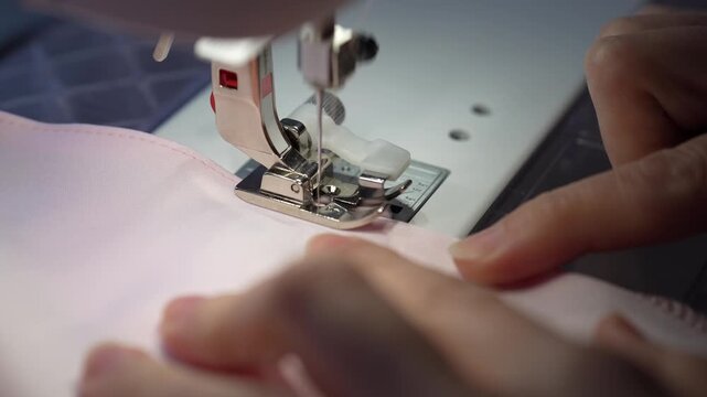 Sewing with precision in a cozy workshop for crafting and creating beautiful garments