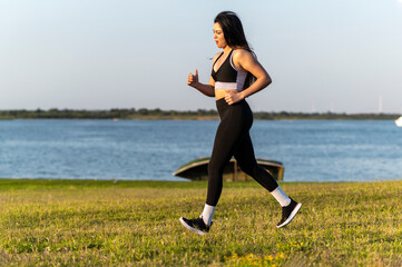 Athletic woman exercising by riverside park, Asuncion, Paraguay