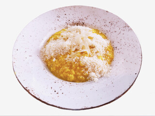 Risotto alla Milanese. Delicious Italian risotto with saffron and Grana Padano, is a hard cheese from the Po Valley. Lombard saffron risotto recipe. Top view. Isolated.