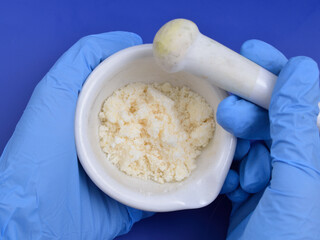 Sodium Oleate powder on light grey background.