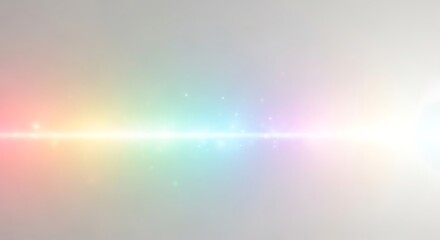 A rainbow of light sparkles against a neutral soft background emanating from a bright white source on the right