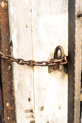 Old Rusty Chain Securing a Metal Door