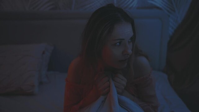 scared frightened woman wakes up at night during lightning storm rain. adult girl has nightmare sleeps paralysis bad dream. dark bedroom bed. suffering insomnia health problems anxiety sleep disorder