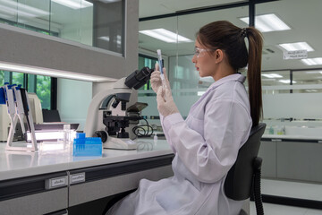 Scientist conducts research in a modern laboratory with equipment and specimens for analysis in broad daylight
