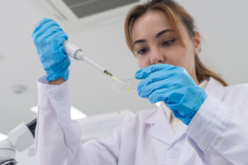 Scientist conducts experiment using a pipette in a modern laboratory setting