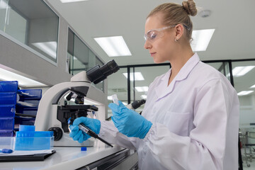 Scientist examines samples using a microscope in a modern laboratory setting