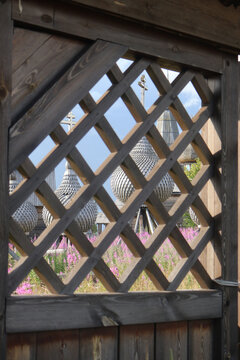 Orthodox wooden church domes behind fence in Varzuga, Russian North