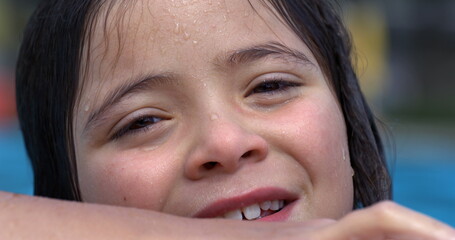 Close-up of a girl smiling at poolside in slow motion at 800 fps, capturing her joyful, wet face,...
