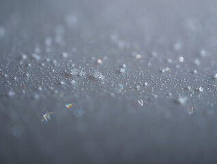 Close up of frost crystals and water droplets on a gray surface