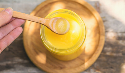 Ghee in a jar in a meadow. Selective focus.