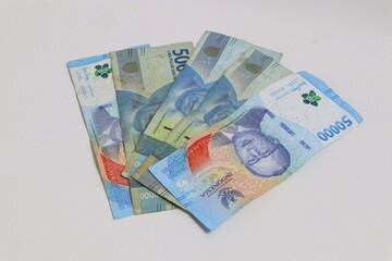 Indonesian Rupiah Currency Bills Spread on a White Surface