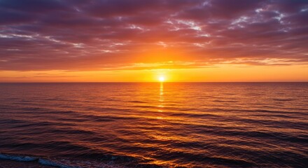 Obraz premium A breathtaking sunset paints the tranquil ocean in hues of orange, pink, and purple, creating a serene and peaceful scene.
