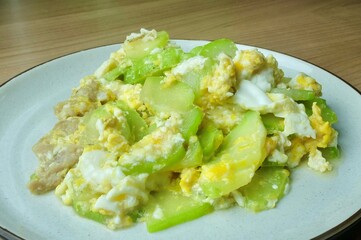 Nutritious and light Thai stir-fry featuring fresh angled luffa or chinese okra and scrambled egg. A wholesome, high-fiber and delicious Asian diet meal.