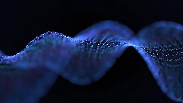 Abstract glowing blue wave of particles moving in darkness, representing data flow or energy.