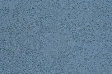 Detailed view of rough blue plaster with visible texture and patterns. Abstract background.