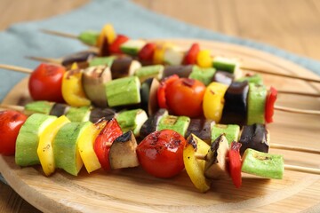 Vegetarian barbecue. Skewers with tasty grilled vegetables on table, closeup