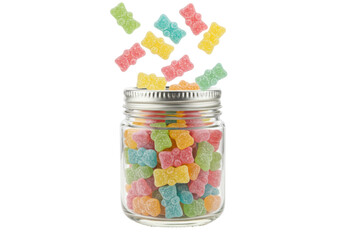 Isolated gummy bear candy filling a clear glass jar; candies fall into it; snack concept