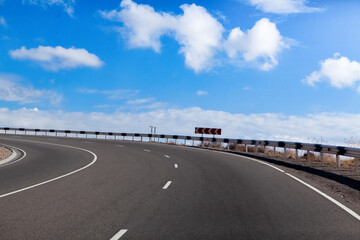 asphalt road and blue sky with clouds