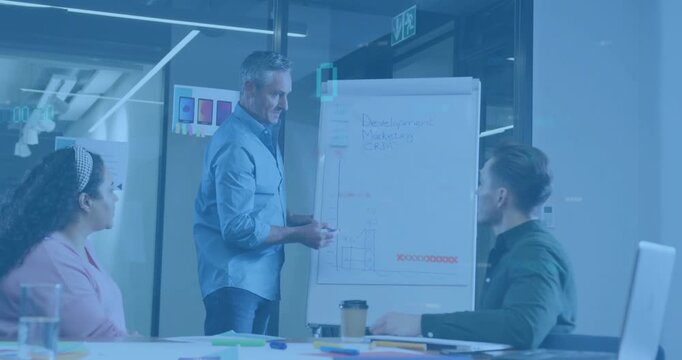 Presenter picking marker and drawing animated marketing graphs on flipchart to illustrate trends