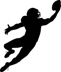 Silhouette of a American football player jumping high catching ball