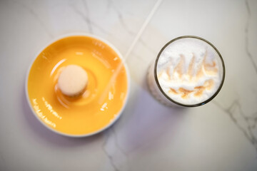Close-up view of a steaming cup of coffee in a white ceramic mug placed on a vibrant yellow saucer, showcasing rich textures and inviting warmth in a cozy setting