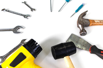Set of tools and equipment, screwdrivers of various sizes, hammer and blower on white background.