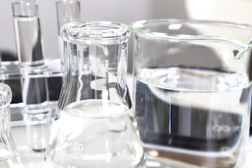Clear bottles and dishes are used in scientific and medical experiments.