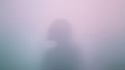 Soft pastel gradient background with a blurred silhouette  