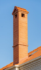 roof of the house is made of red tiles