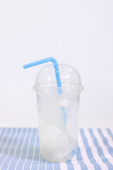 Fresh Young Coconut Water in a Cup on a Placemat, White Background
